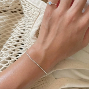Macro detail of minimalist S925 sterling silver chain and ring with opal gemstone