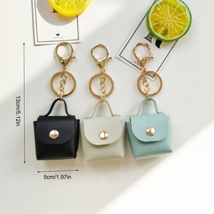 Detailed dimensions of three mini leather keychain bags with measurements 13cm by 5cm
