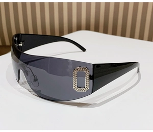 Close-up of Y2K rimless sunglasses featuring a rhinestone O-shape detail on the side temple