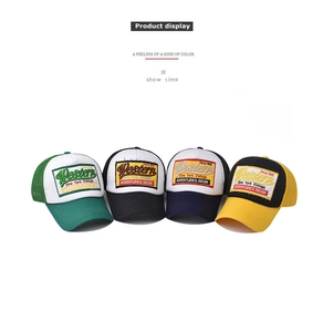 Detailed close-up showing various colors of Western embroidered mesh trucker caps.