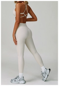Detail of cross back yoga set with sports bra and high-waisted lifting leggings in off-white