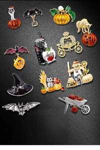Collection of Halloween brooches including pumpkins, bats, and ghosts with enamel finish
