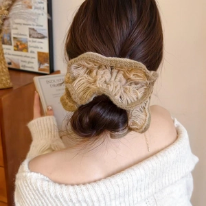 Knitted double-layer flower hair scrunchie shown on an elegant ponytail hairstyle