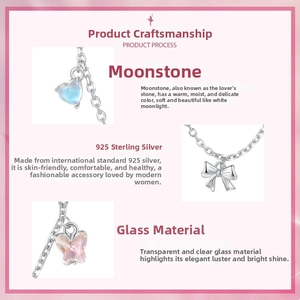 Detail of s925 silver ballet bow safety chain with heart moonstone and butterfly charms