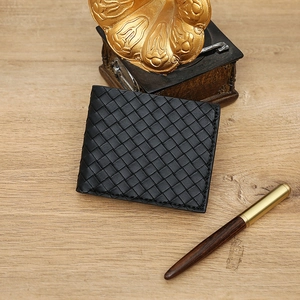 Classic black woven bifold men's wallet with Intrecciato leather texture on wood