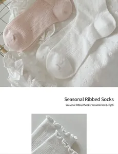 Close-up of white and pink cotton mid-calf socks with sweet ruffle edge details