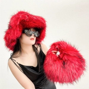Close-up of fluffy red faux fur handbag and matching hat set with vibrant texture