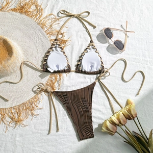 Close-up of brown and beige two-piece bikini featuring wavy textured fabric and braided trim