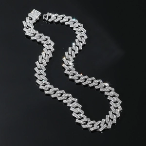 Macro shot of silver hip-hop Cuban link chain with sparkling rhinestones on black background