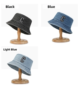 Detail view of denim bucket hats with checkerboard C patch in black and blue denim