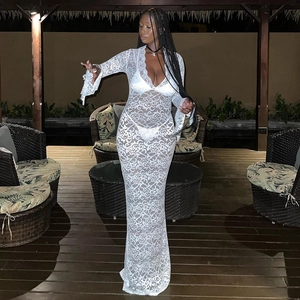 Close-up of white lace see-through dress with V-neck and flared sleeves on model