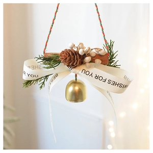 Detail of Christmas ornament featuring pine cones, cinnamon sticks and metal bells