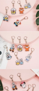 Detailed view of cute acrylic animal keychains on pink decorative display stands