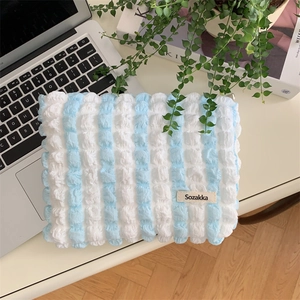 Detailed view of blue and white bubble texture fabric on a large canvas storage bag
