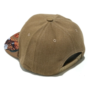 Brown flat brim baseball cap featuring anime print under-brim and snapback closure