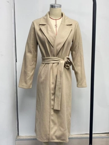 Detail of lapel collar and waist tie belt on a beige long wool blend coat for women