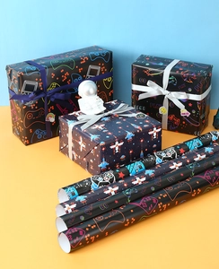 Macro detail of gaming-themed gift wrapping paper with controller and pixel art patterns