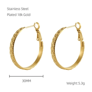 Detail view of 30mm diamond textured 18k gold plated stainless steel hoop earrings