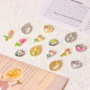 DIY jewelry making charms featuring enamel tulip and peach designs with gold frames