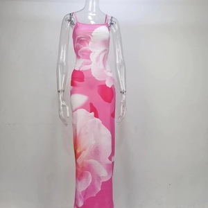 Detail of slim fit pink floral slip dress with high slit and realistic flower patterns
