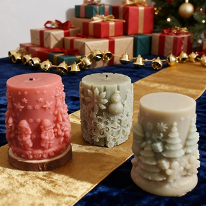 Embossed Christmas cylinder candles with reindeer and snowman patterns on silk
