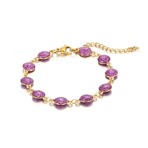 Detail of 18k gold-plated bracelet featuring purple glitter discs and lobster clasp closure