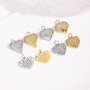 Chic 18k gold plated heart pendants with pearls and zircons on white surface