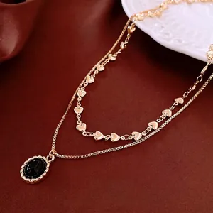 Vintage gold plated double layer necklace with heart links and black oval pendant