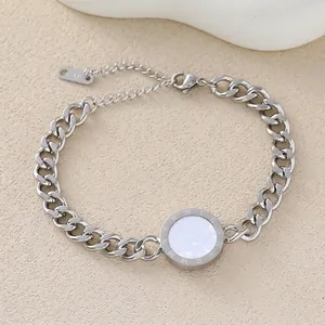 Detail of silver cuban chain bracelet with Roman numeral pendant and pearl shell inlay