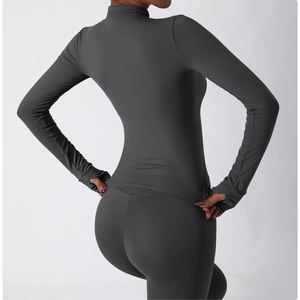 Detail view of the thumb hole cuff on a dark gray zip-up sports jacket for women