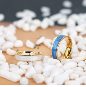 Macro shot of 18K gold plated rings with blue and white enamel marble textures