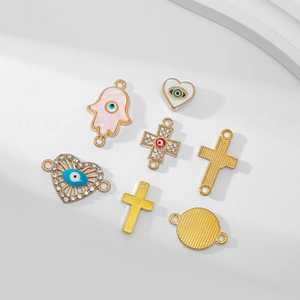 Set of 10 evil eye charms with hamsa and cross shapes in gold metal for DIY jewelry making