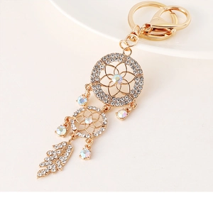 Close-up of gold dreamcatcher keychain with sparkling rhinestones and crystal leaf detail