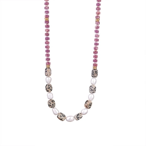 Macro shot of handmade necklace with pink stones, freshwater pearls and spotted marble beads