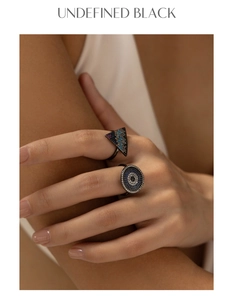 Detailed macro view of S925 silver rings with pavé crystals and geometric triangle design