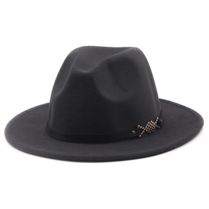 Detail of wide brim fedora hat featuring a leather band with silver metal ornaments