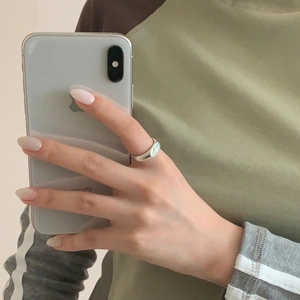 Macro shot of silver eight-pointed star signet ring during a mirror selfie session