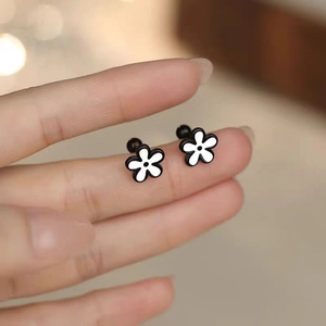 Minimalist gold daisy stud earrings with black and white enamel finish for women