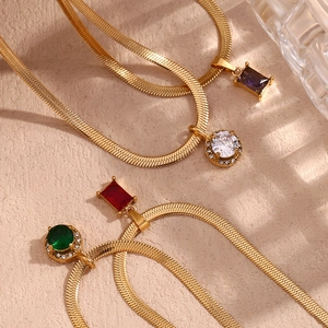 Detail view of 18K gold plated flat snake chain necklaces with colorful zircon pendants