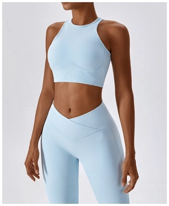 Detail of high-waist light blue yoga leggings with V-shaped crossover waistband