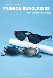 Fashion cat-eye sunglasses set featuring black and transparent grey frames on a blue stand