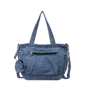 Blue denim tote bag with shoulder strap and mini coin purse on white background