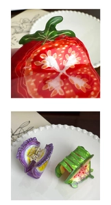 Detailed view of glossy fruit slice hair clips featuring tomato and watermelon designs