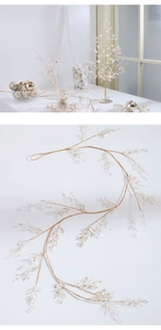 Macro detail of golden branch ornament with translucent frosted leaves for Christmas decor