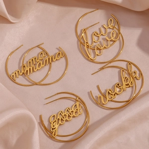 Detail of 18K gold-plated stainless steel hoop earrings with mama love rock good charms