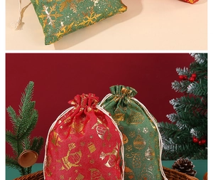 Detail of red and green cotton Christmas drawstring bags with gold reindeer patterns