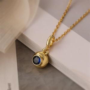 Golden heart-shaped necklace with blue zircon pendant on a minimalist chain