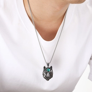 Macro shot of Fenrir wolf pendant with green opal inlay and vintage steel details