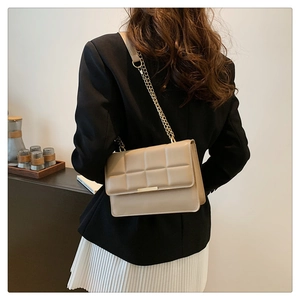 Elegant beige quilted shoulder bag with gold chain strap and metallic clasp closure