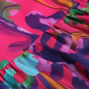 Macro detail of vibrant floral print fabric and pleated stitching on summer dress